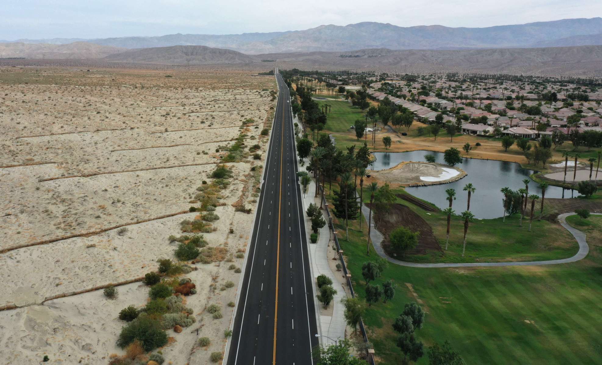 An aerial view shows a golf course next to desert landscape as California faces its worst drought since 1977, in Palm Springs, California, U.S., June 29, 2021. Picture taken with a drone June 29, 2021.