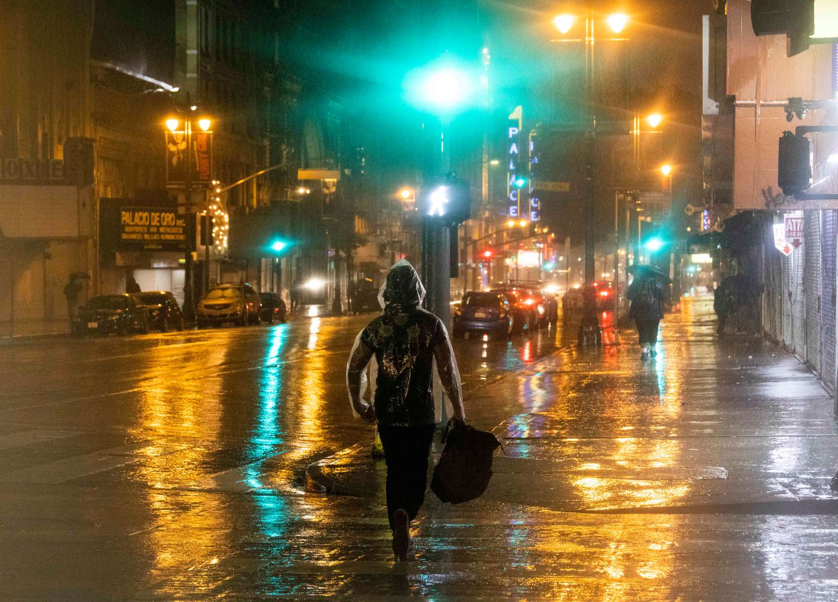 People walk downtown during one of the wettest recorded  days in Los Angeles, California, U.S., February 4, 2024.  