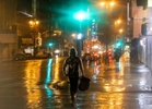 People walk downtown during one of the wettest recorded  days in Los Angeles, California, U.S., February 4, 2024.  