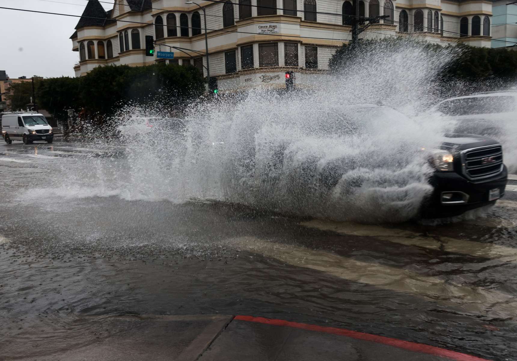 Cars drive on flooded streets during the ongoing rain storm in Studio City, California, U.S., February 5, 2024.  