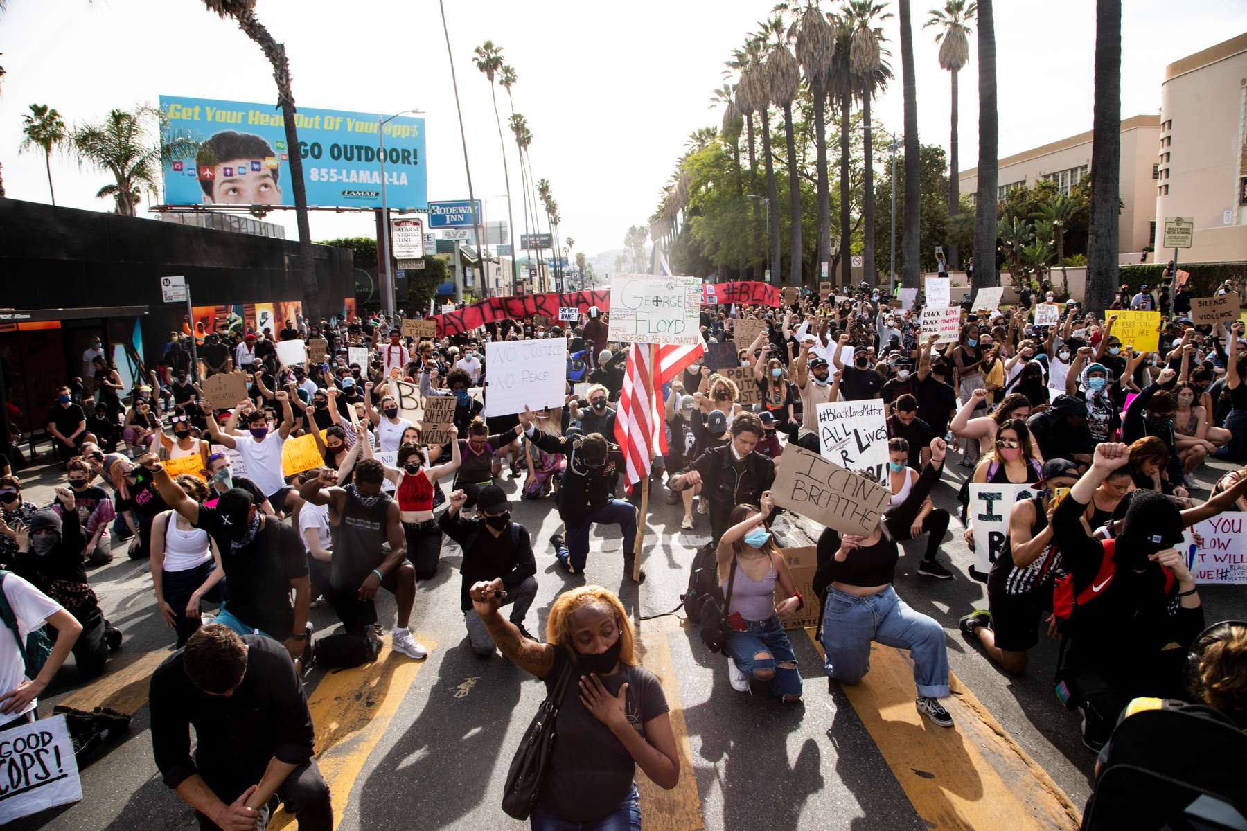 Protesters take a knee during a march over the death of George Floyd, an unarmed black man, who died after a police officer kneeled on his neck for several minutes in the Hollywood neighborhood on June 1, 2020, in Los Angeles, California.