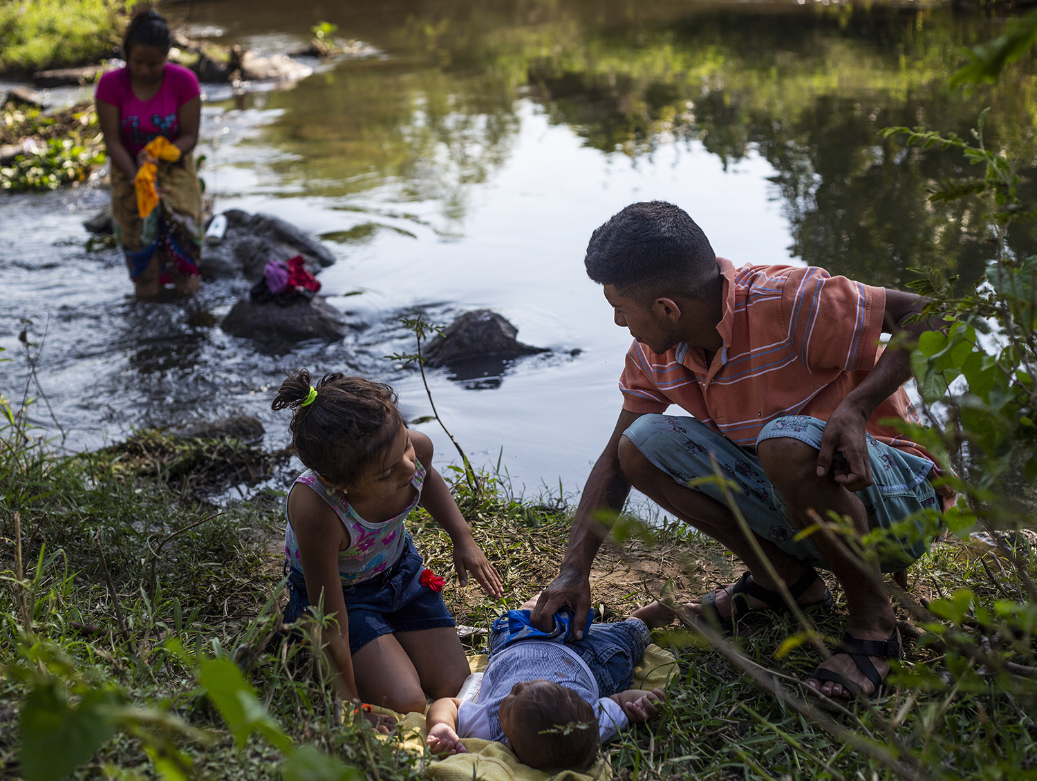 A family takes a bath in the river after a very early walk  in Chahuites, Mexico November 8, 2021. 