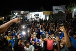 Migrants cheers after listening to a speech of Irineo Mujica, the caravan organizer, in Chahuites, Mexico November 8, 2021. 