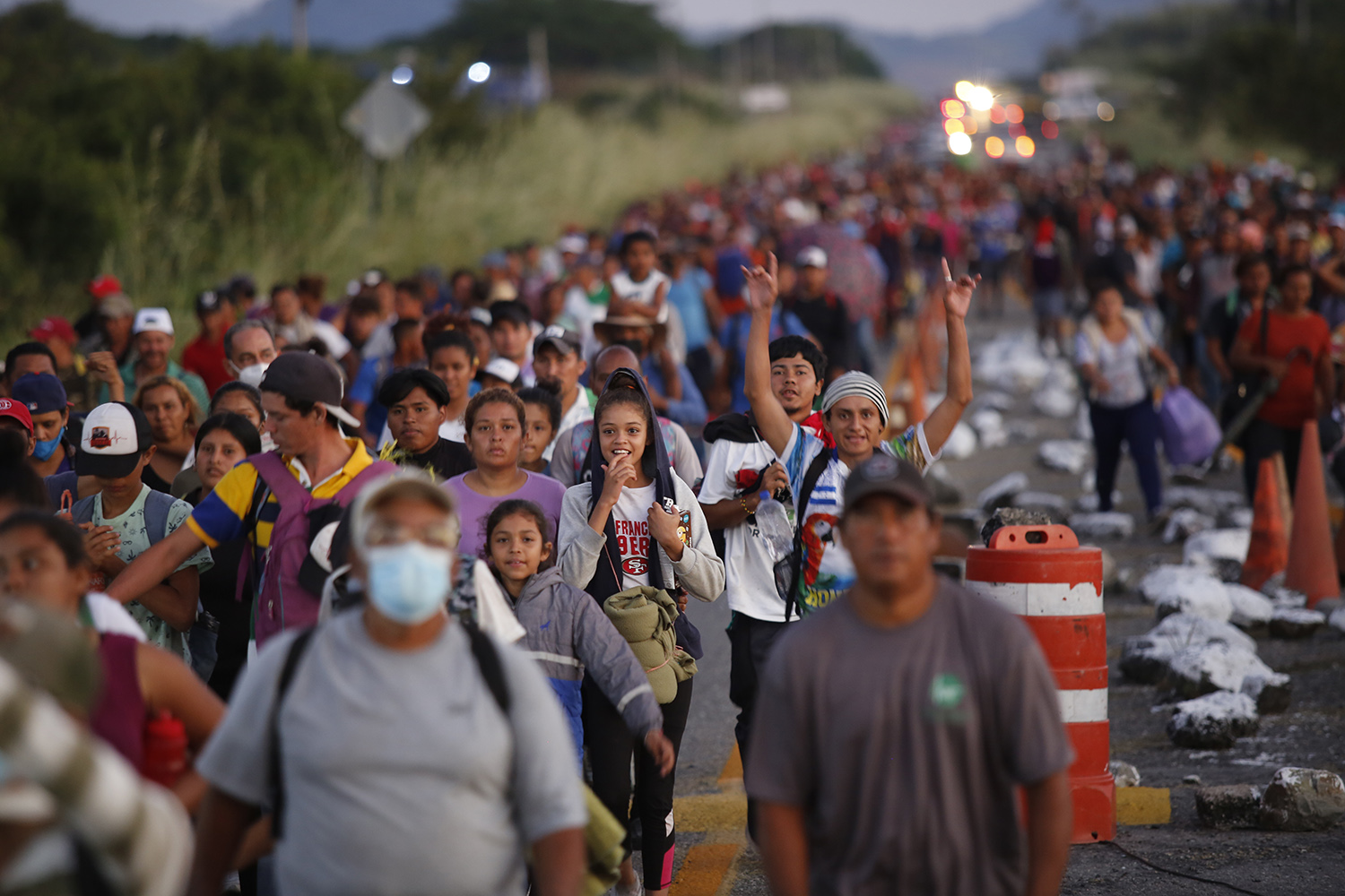 Migrants walk along a road in a caravan heading to the northern border, in Tapanatepec, Mexico November 9, 2021.