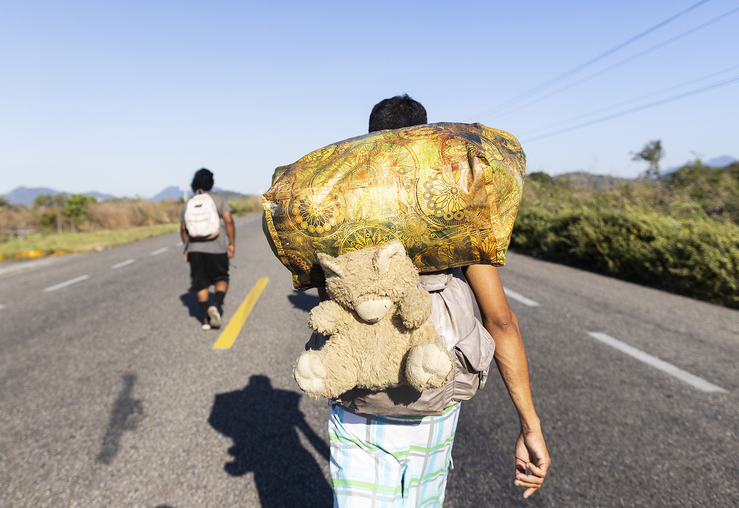 A migrant  walks along a road in a caravan heading to the northern border,  in Chahuites, Mexico November 8, 2021. 