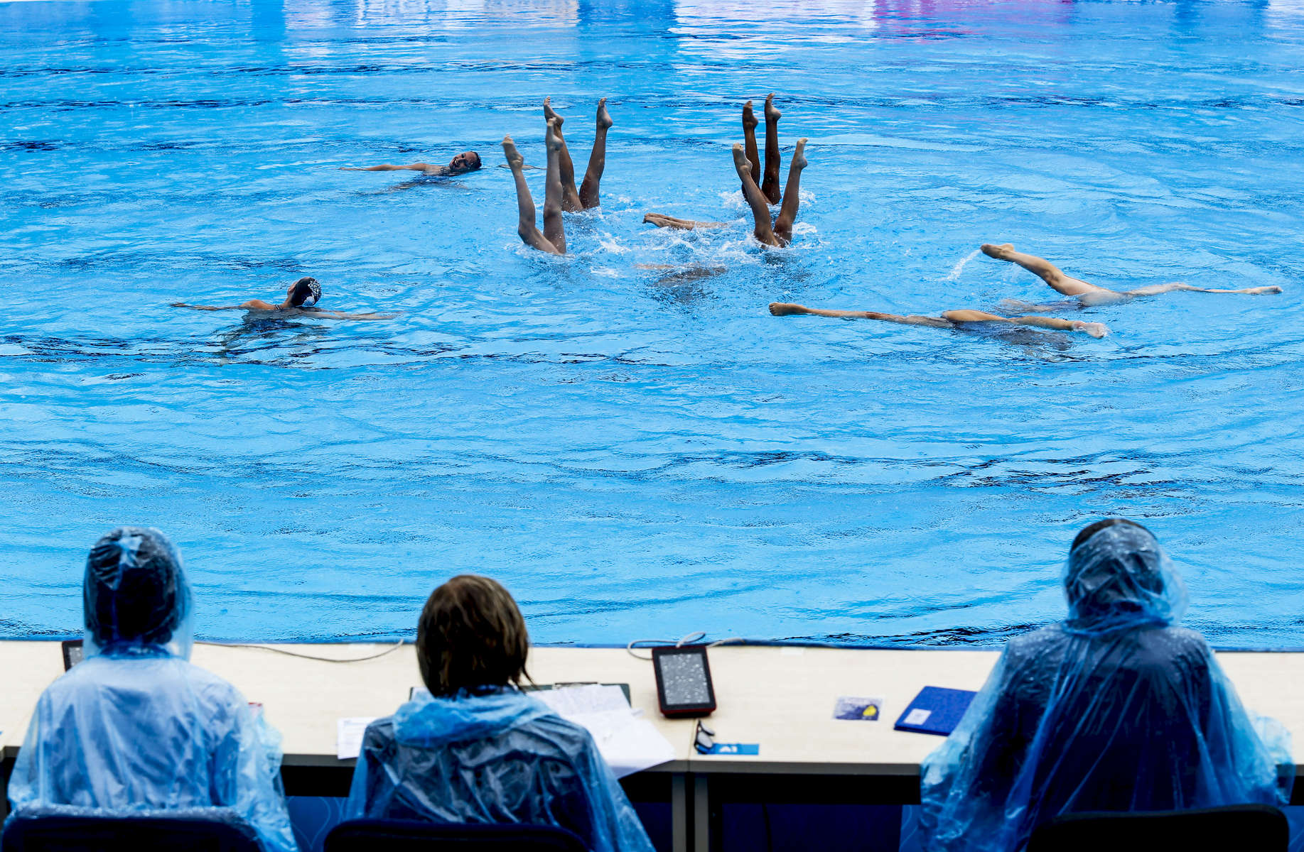 The Spanish team performs in front of the judges on a rainy morning for the Synchronised Swimming Combination Free finals, during the FINA World championships in Budapest, Hungary on July 22, 2017.