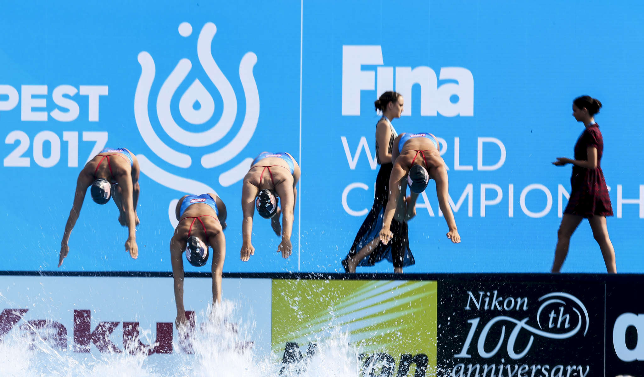 The American team practices before competing in the Synchronised Swimming Team Free finals, while the FINA team rehearses the medals ceremony, during the FINA World championships in Budapest, Hungary on July 21, 2017.