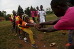 Participants play a game between competitions at the {quote}Women take the Lead{quote} festival, a soccer event for Congolese refugee youth in Kampala, Uganda.