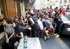 Supporters try to watch the World Cup Soccer final on the TV screen of a bar, on July 15, 2018, in Paris, France.On the historical Soccer World Cup final between France and Croatia, fans were invited to watch the game on giant screens set up in the Champs de Mars, in front of the Eiffel Tower in Paris. But this Fan Zone was full long before the start of the game, leaving thousand of supporters scrambling to find a place to watch the game close by. The nearby and usually quiet coffees and restaurants were quickly over flooded. But for the next two and a half hours, it did not matter to watch the game from the middle of the streets. Very few cars were circulating, because almost everyone in France was watching, or trying to watch the game. 