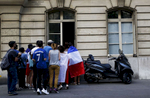 Supporters try to watch the World Cup Soccer final on the TV of a private apartment, on July 15, 2018, in Paris, France.On the historical Soccer World Cup final between France and Croatia, fans were invited to watch the game on giant screens set up in the Champs de Mars, in front of the Eiffel Tower in Paris. But this Fan Zone was full long before the start of the game, leaving thousand of supporters scrambling to find a place to watch the game close by. The nearby and usually quiet coffees and restaurants were quickly over flooded. But for the next two and a half hours, it did not matter to watch the game from the middle of the streets. Very few cars were circulating, because almost everyone in France was watching, or trying to watch the game. 