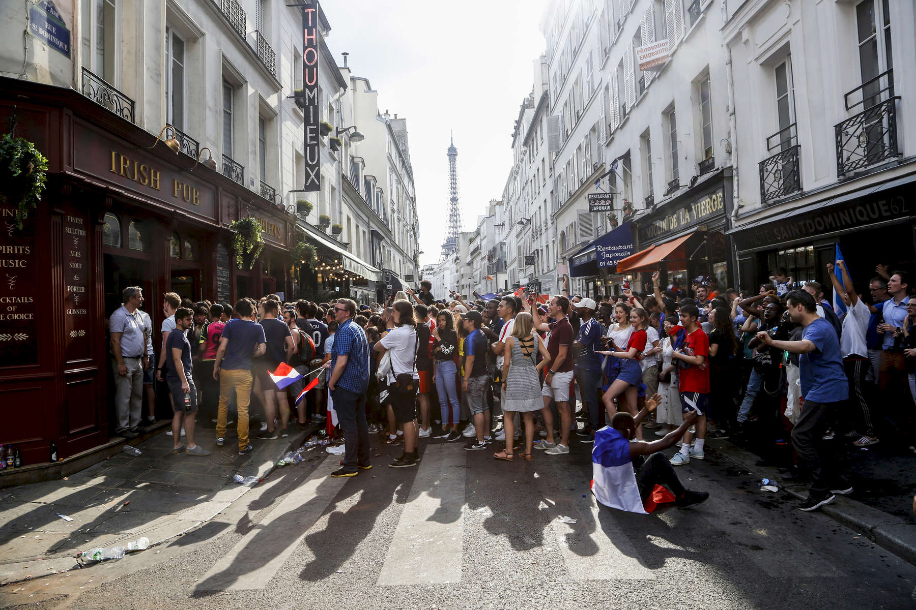 Supporters watch the World Cup Soccer final on the TV of a bar, on July 15, 2018, in Paris France.On the historical Soccer World Cup final between France and Croatia, fans were invited to watch the game on giant screens set up in the Champs de Mars, in front of the Eiffel Tower in Paris. But this Fan Zone was full long before the start of the game, leaving thousand of supporters scrambling to find a place to watch the game close by. The nearby and usually quiet coffees and restaurants were quickly over flooded. But for the next two and a half hours, it did not matter to watch the game from the middle of the streets. Very few cars were circulating, because almost everyone in France was watching, or trying to watch the game. 
