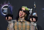 Billie Eilish poses in the press room with the award for new artist of the year and favorite alternative rock artist at the American Music Awards on Sunday, Nov. 24, 2019, at the Microsoft Theater in Los Angeles. (Photo by Jordan Strauss/Invision/AP)
