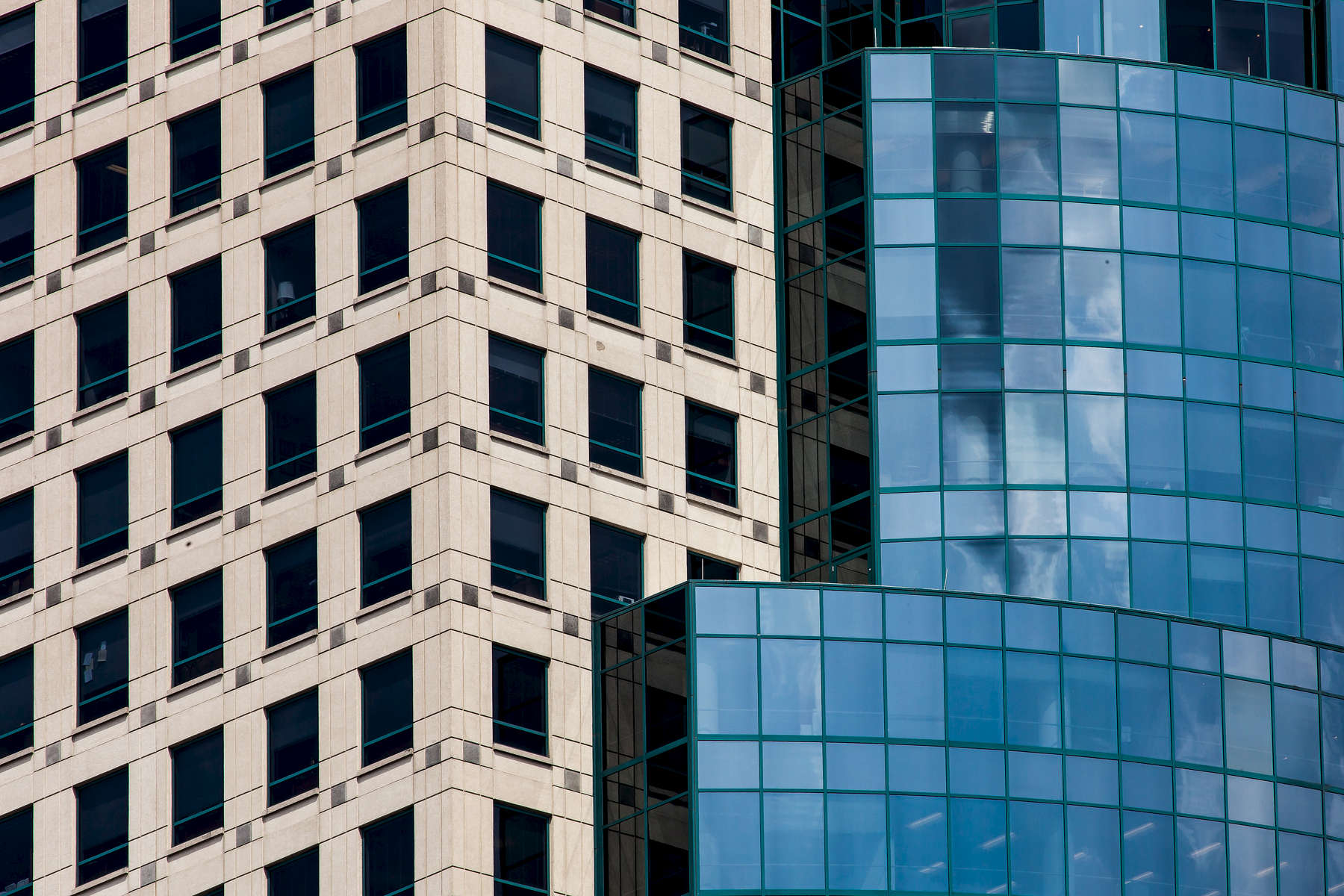 Scripps Center - Downtown Cincinnati, OH.  This image was taken from the corner of the building, which, in my opinion, has more visual interest.  From this perspective, it almost looks like two buildings, one glass and the other masonry.  This angle and close framing accentuates the contrasting visual between glass and masonry.  I think the ninety-degree angle at the corner breaks up the straight linear pattern of the windows adding depth.  My idea was to give the viewer access to an aspect of the building that is different than the primary visual at street level.Scripps Center is a Class A 35-story office building that opened in 1990. Developed by Cincinnati real estate and philanthropic icon Manuel D. Mayerson, Scripps Center is the first premiere Class A office building on the Cincinnati riverfront, defining the city’s skyline.  At the height of 468.01 feet (142.65 m), with 35 stories, it is the fourth tallest building in the city.The building was designed by Houston architects Hoover & Furr; Glaser & Associates was architect of record.  Space Design International was also involved with the building's design.The headquarters of the E. W. Scripps Company is located in the Scripps Center.