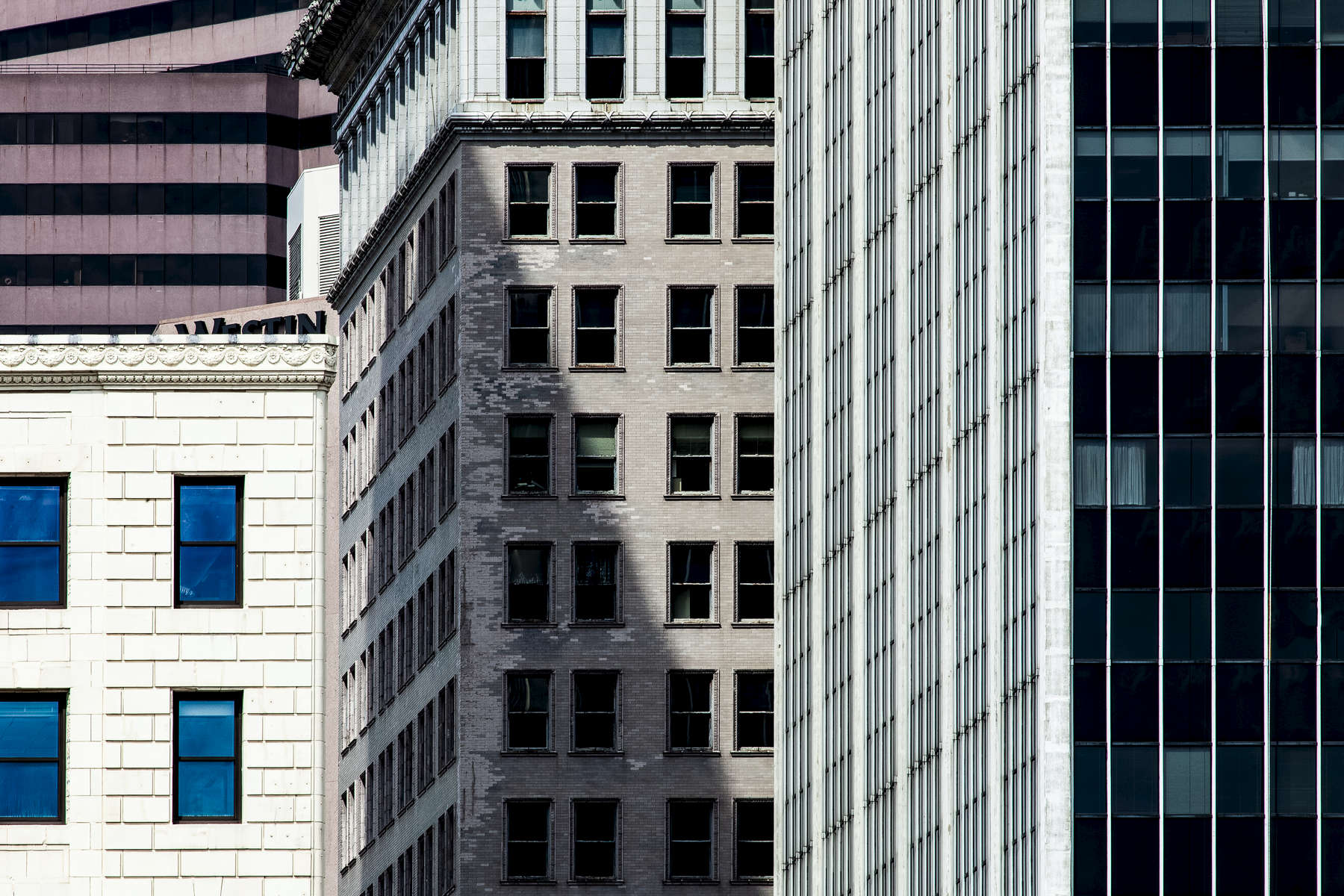 Downtown Cincinnati, Ohio.  I think the striking juxtaposition of strong vertical and horizontal patterns of the building design, different architectural styles and age, and close proximity of massive structures to each other are a large part of what makes a city unique.