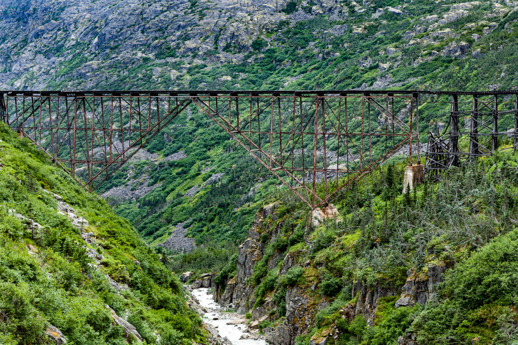 Skagway, Alaska - Perhaps the most intriguing of Skagway's bridges, the Switchback Arch Bridge, is a train bridge over the plunging White Pass chasm. The bridge was built in 1900 to make travel easier and faster for gold prospectors trekking from Skagway to the Canadian Klondike via the White Pass trail.  The bridge was abandoned in 1969. 