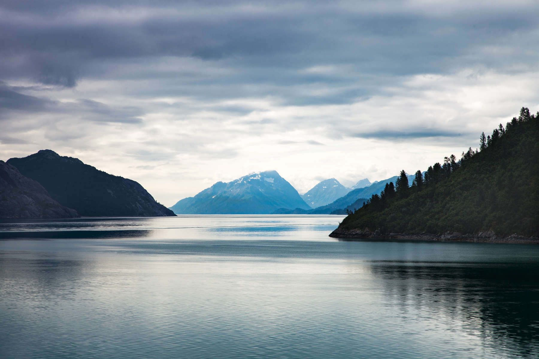 Glacier Bay, Alaska - This image was taken near the mouth of one of the many beautiful fjords along the coast of Glacier Bay, Alaska. Covering 3.3 million acres of rugged mountains, dynamic glaciers, temperate rainforest, wild coastlines and deep sheltered fjords, Glacier Bay National Park is a highlight of Alaska's Inside Passage and part of a 25-million acre World Heritage Site—one of the world’s largest international protected areas.