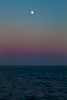 An eerie sense of timelessness comes over seafaring travellers near Seward, Alaska as faint rays from the midnight sun glimmer on the horizon, and a glint of moonlight kisses the waves.  Photo was taken at 1:50 AM on July 17, 2016.