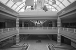 Forest Fair Village (formerly Cincinnati Mall, Cincinnati Mills, and Forest Fair Mall) is a shopping mall in the northern suburbs of Cincinnati, Ohio.  This view from the upper level in front of Kohl’s overlooks the once vibrant promenade below.  Sadly, the promenade and the upper corridors are now empty except for a few mall walkers.Image from upper level escalator in front of Kohl's entance.  Kohl's is one of a handful retailers remaining.  The interior mall area  is well maintained and clean, as though expecting a rush of shoppers that never come.  Only dark, empty corridors that reminded me of scenes from the Twighlight Zone television series. 