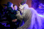 A participant dressed as the Krampus creature greets a child during the Krampus gathering in Goricane, Slovenia, Nov. 21, 2015. In Central European alpine folklore, Krampus is a demonic creature traditionally following St. Nicholas and angels on the evening of December 5. It pries on children who were not good during the year.