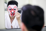 Wang Lu who plays the Monkey King puts on makeup before the China National Peking Opera Company performance of the Monkey King in Cankarjev dom Culture and Congress Center in Ljubljana, Slovenia, Dec. 31, 2015.