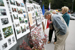 People admire the exhibition of photographs showing the history of the oldtimers\' race at the 19th Hrast Memorial, the international oldtimers\' mountain race in Ljubelj, Slovenia, Sep. 13, 2015.