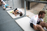 Exhausted competitors rest after running up the ski flying hill during the Red Bull 400 race in Planica, Slovenia, Sep. 19, 2015.