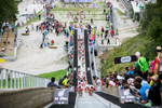 Competitors run up the ski flying hill during the Red Bull 400 race in Planica, Slovenia, Sep. 19, 2015.
