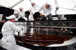 Confectioners glaze the world's largest original Sacher-torte with chocolate in Ljubljana, Slovenia, Sept. 21, 2016. The largest original Sacher-cake was made to mark the ending of the Vienna Days in Ljubljana.