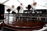 Confectioners glaze the world's largest original Sacher-torte with chocolate in Ljubljana, Slovenia, Sept. 21, 2016. The largest original Sacher-cake was made to mark the ending of the Vienna Days in Ljubljana.