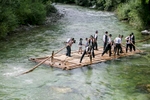 Raftsmen navigate a traditional raft down the Savinja river during the 55th Raftsmen Ball in Ljubno ob Savinji, Slovenia.
