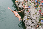 A competitor dives from a bridge over river Soca during an annual diving competition in Kanal, Slovenia, August 16, 2015.