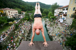 A competitor prepares to dive from a bridge over river Soca during an annual diving competition in Kanal, Slovenia, August 16, 2015.