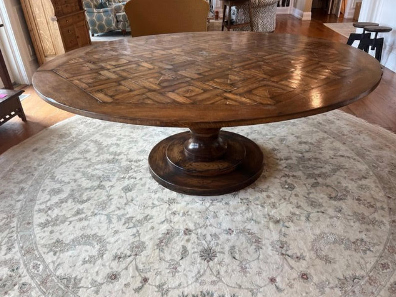 This elegant six-foot round table features a sturdy pedestal base and an intricate 9-inch parquet design. It’s beautiful character is enhanced by a rich walnut patina and a rich distressed finish. This spacious table comfortably accommodates eight to ten people, making it an impressive addition to any dining room or breakfast nook.72{quote}diam x 28.5”hOur Price $3,000