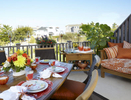 outdoor terrace with walter's wicker furniture and orange sunbrella fabrics