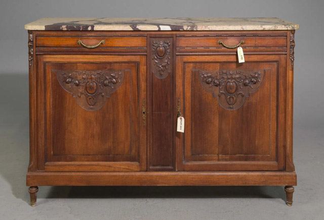 The French Louis XVI marble-top buffet is a quintessential example of the Neoclassical revival. Its elegantly veined original Breche marble top makes it ideal for entertaining and enjoyment. The buffet features a pair of drawers bordered with beaded trim, each adorned with intricately designed pulls that depict laurel garlands. The center stile and doors showcase relief floral designs.59.5” x 20” x 40”Our Price $3,500