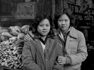 Zee Ying Chan Wong with her daughter Lina Wong, in front of their grocery store, Catherine St., NYC, 1981.