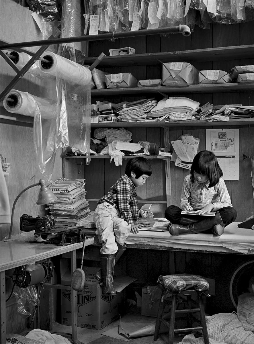 Hand laundry, Queens, New York, 1981. Children do their homework in the family hand laundry.