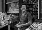 Frankie Wong in front of his grocery store on Catherine St., New York City, 1981.