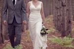Bride and groom walking in the woods, Traverse City Michigan wedding. 