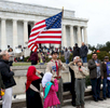 A Muslim boy scout carries the American flag as the Pledge of Allegiance is recited at an interfaith celebration of Christmas and Mawlid, an observance of the birthday of Prophet Muhammad, in front of the Lincoln Memorial in Washington, D.C., Saturday, December 26, 2015. The event, organized by the American Muslim Institution and ADAMS Center, included singing Christmas carols and songs about Prophet Muhammad.