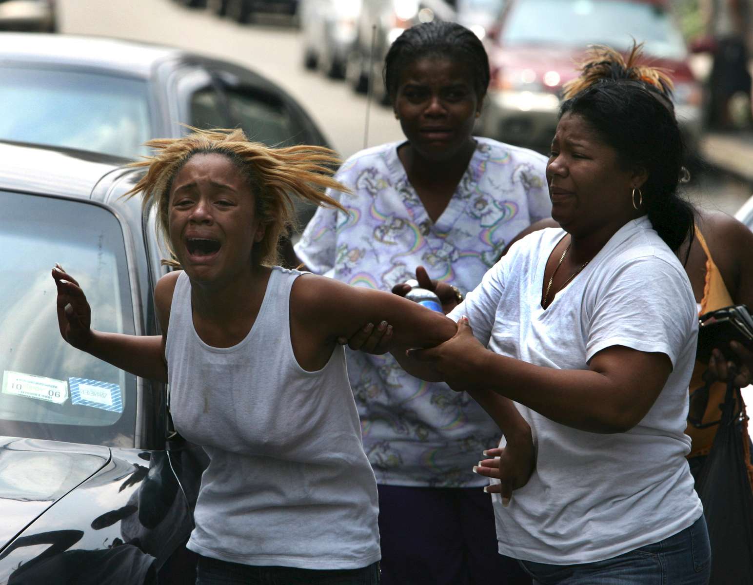 Shataiva Mills, 18, (left) is comforted by her mother after learning of the death of her fiance, Keywann Gardiner, who was killed with 4 other family members in a four-car pileup on the Bronx River Parkway on July 10, 2006. 
