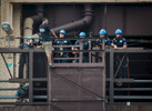 Members of the NYPD Emergency Service Unit talk down a suicidal man from the edge of Queens Borough Bridge as he threatens to jump off, down to Roosevelt Island on Tuesday, August 12, 2014.