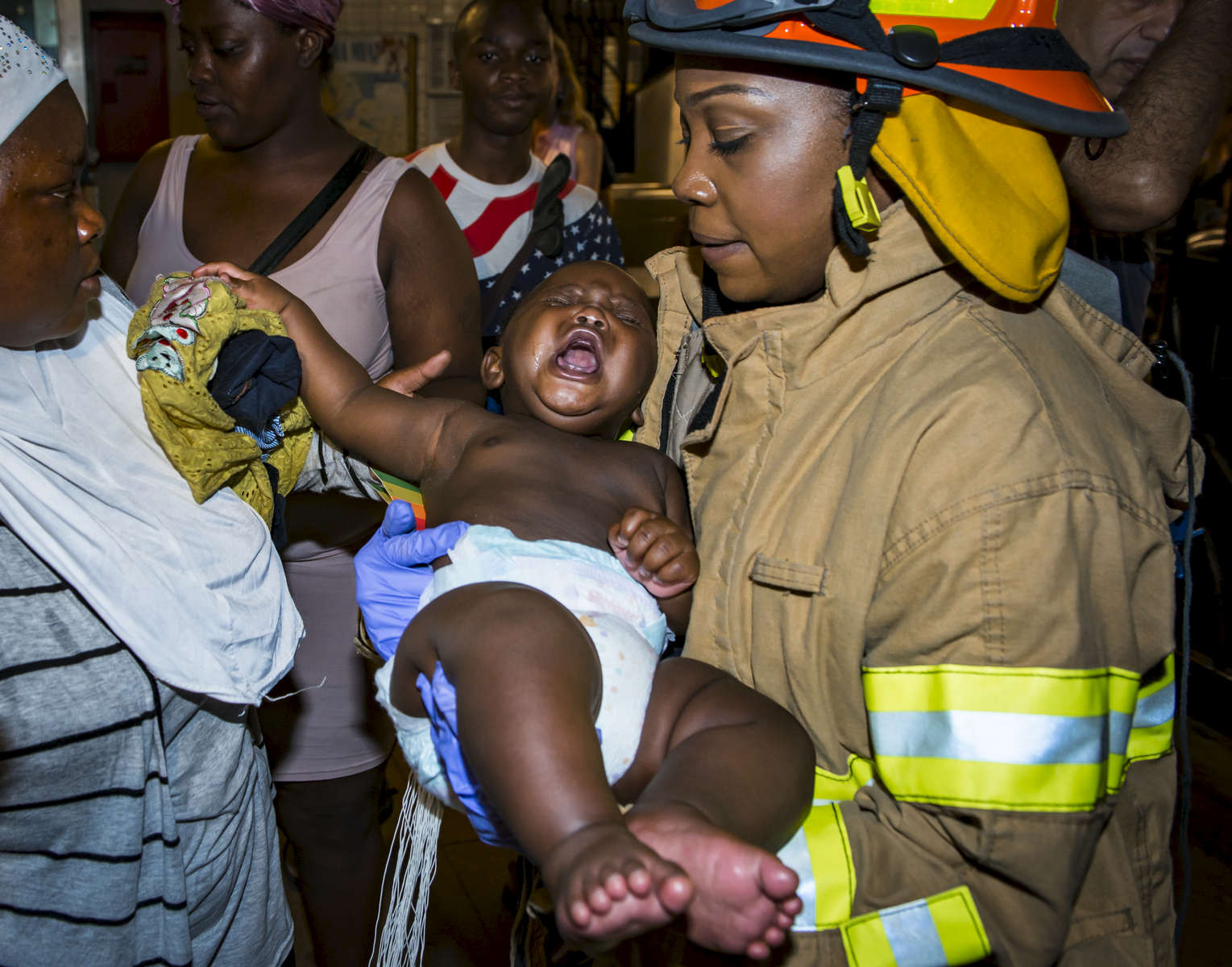 Emergency Medical Technician Tuanika Brown rescues a baby after a train derailment at St. Nicholas Avenue and West 135th Street in Harlem on Tuesday, June 27, 2017. Hundreds of people were evacuated and thirty four straphangers suffered non-life-threatening injuries.  