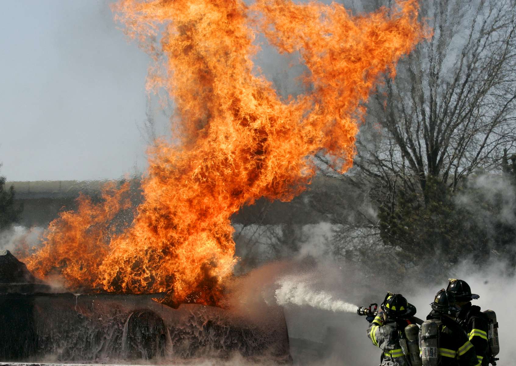 Firefighters battle the fire after a gasoline tank truck overturned and burst into flames at Van Wyck Expressway near North Conduit Avenue in Queens on March 03, 2008. 