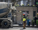  A construction worker rest on the cement truck pouring slide as he and his fellow workers take their lunch break at the corner of West 40th Street and 6th Avenue in Manhattan on Monday, April 10, 2017. 