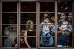 Spectators enjoy watching Macy’s Thanksgiving Day Parade 2016 from their window, as participants pass along Central Park West in Manhattan on Thursday, November 24, 2016. (Anthony DelMundo/New York Daily News)