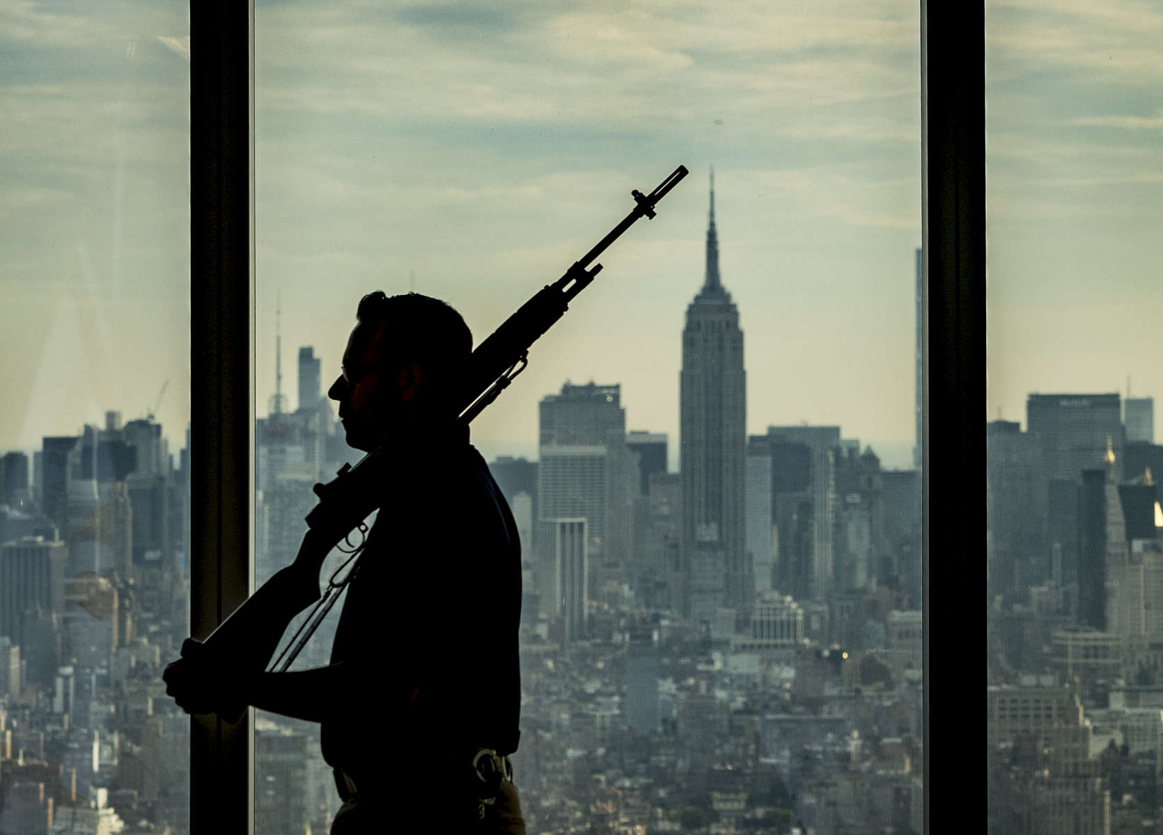 A member of the U.S. Department of Homeland Security Honor Guards is silhouetted against a backdrop of the New York City skyline as he participates on a ceremony commemorating the Federal government’s return to One World Trade Center. The event was held on the 63rd floor of One World Trade Center in Manhattan on Friday, September 9, 2016. 