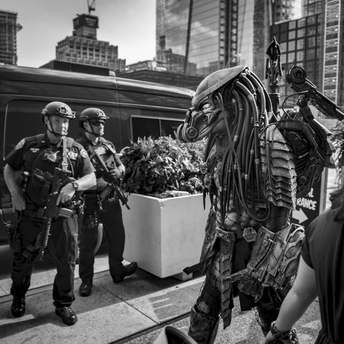 A person wearing the Predator costume, based on the movie Predator starring Arnold Schwarzenegger, walks by members of the NYPD Emergency Service Unit at the New York City Comic Con held at the Jacob K. Javits Convention Center located at 655 W. 34th Street in Manhattan on Friday, October 6, 2017. The New York Comic Con attracts thousand of spectators, comic books and sci-fi fanatics.