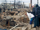 A woman weeps as she came back to see her destroyed home in Breezy Point, New York from a massive fire caused by hurricane Sandy on Wednesday, October 31, 2012.