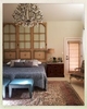 The offbeat placement of the antique French doors beyond an exquisite chandelier induces the lofty to operatic.